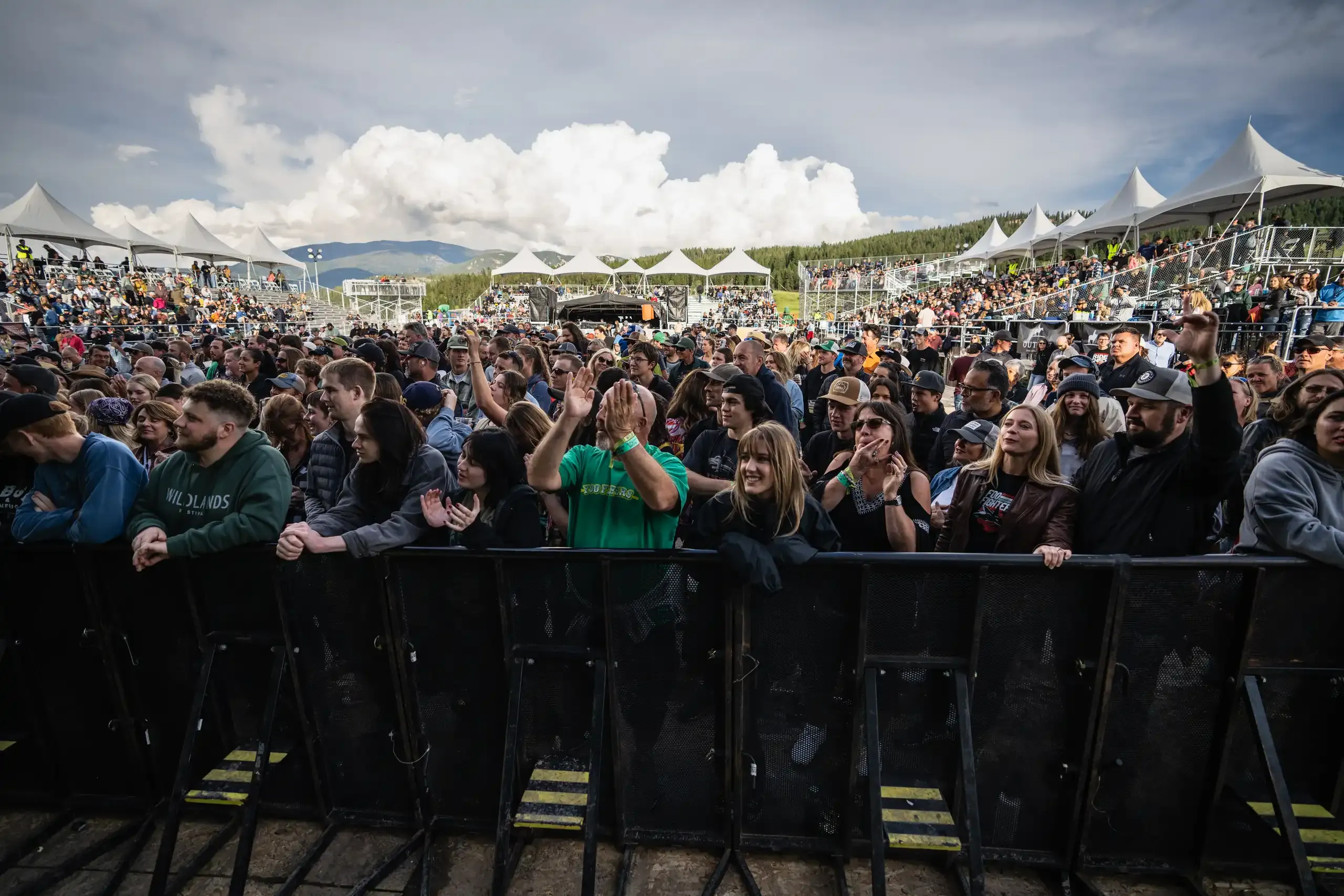 Wildlands audience cheering at the front barrier in 2023.