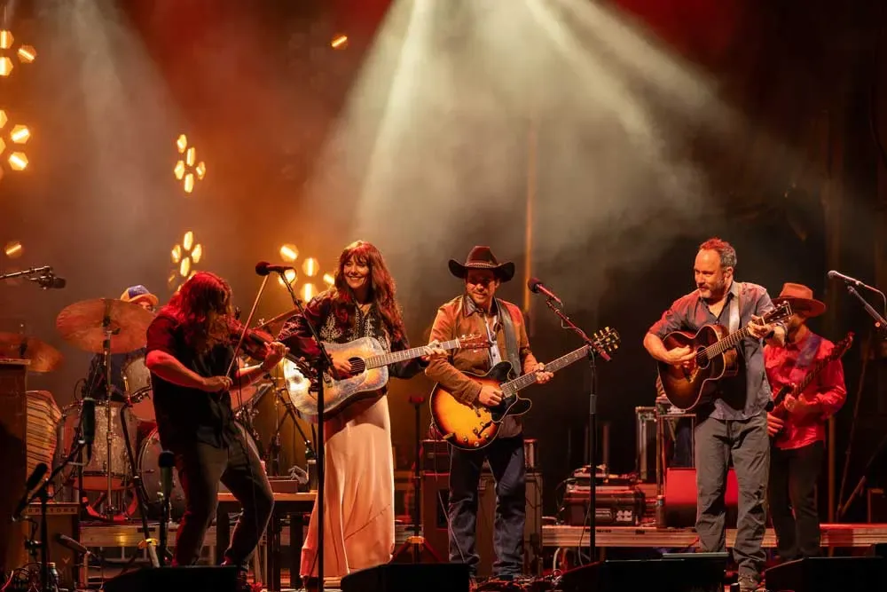 Molly Tuttle, Lukas Nelson and Dave Matthews at Wildlands. A group of musicians performing together under warm stage lights.