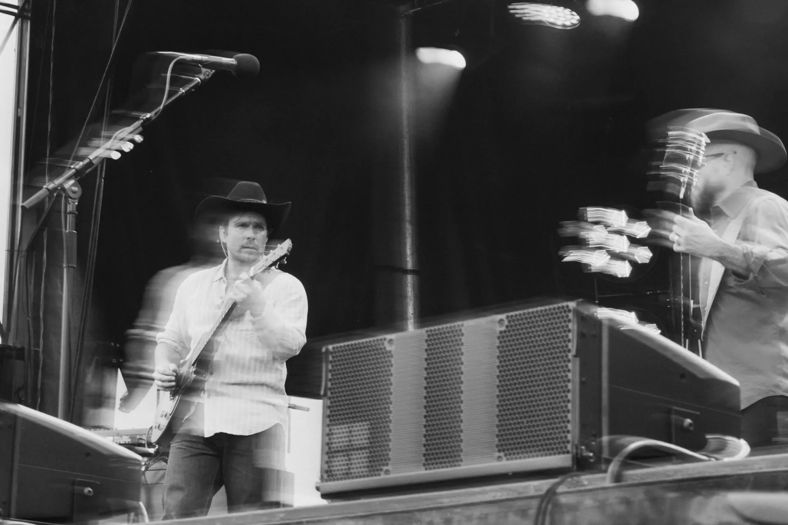 Lukas Nelson at Wildlands. Close view of a musician playing an acoustic guitar onstage.